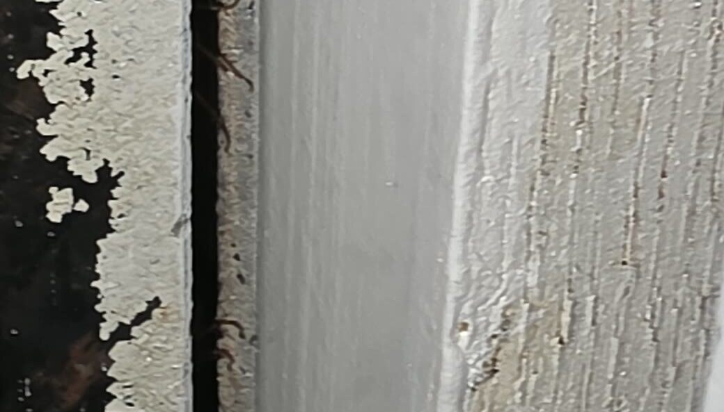 Cockroach activity concealed inside a cabinet crack